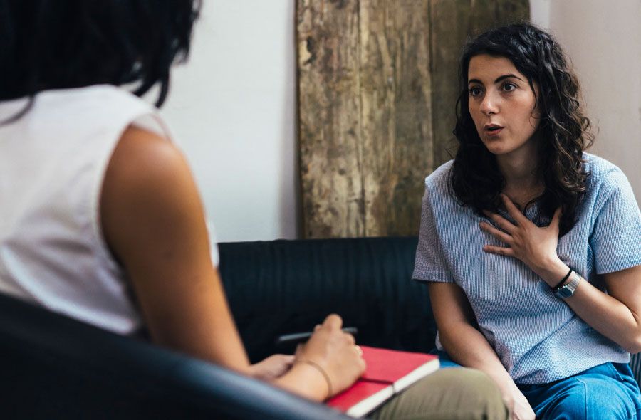 Image of a young woman speaking with a therapist