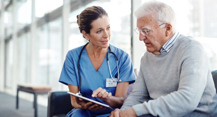 Image of a doctor speaking to an elderly patient